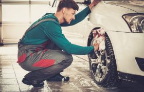 man-worker-washing-car-s-alloy-rims-on-a-car-wash.jpg